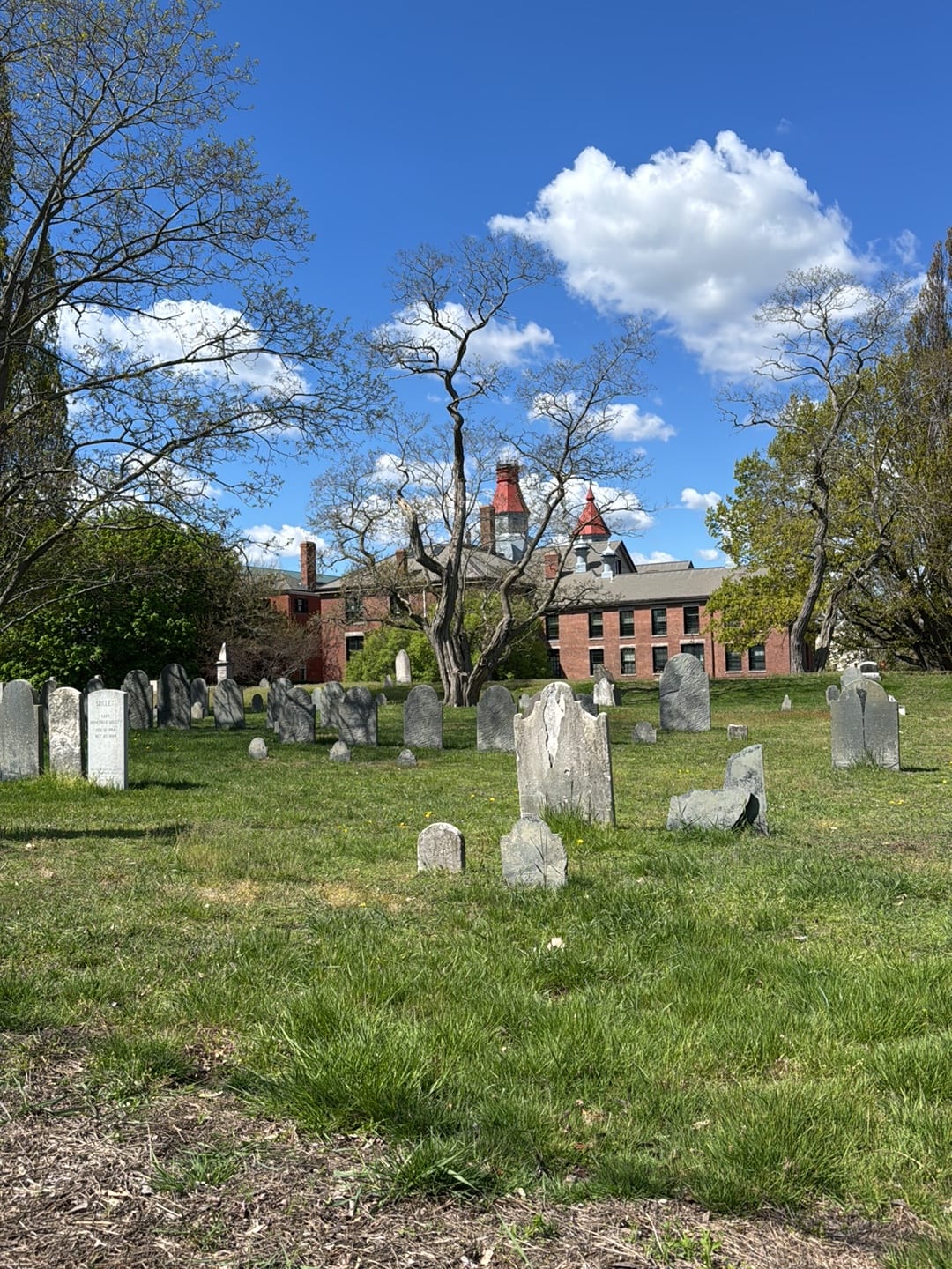 Howard Street Cemetery in Salem, MA on a clear day — the historic burying ground beside the old jail site where Giles Corey was pressed to death in 1692