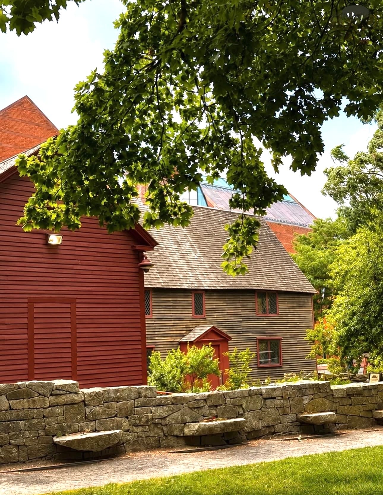 The First Period Samuel Pickman House, a weathered clapboard home (c. 1664) with diamond-paned windows, beside a red colonial building with the Peabody Essex Museum behind, Salem MA