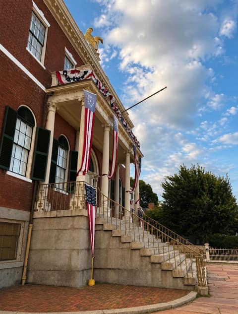 The 1819 Custom House at Salem Maritime National Historic Site, crowned by its gold eagle and draped in patriotic bunting and flags